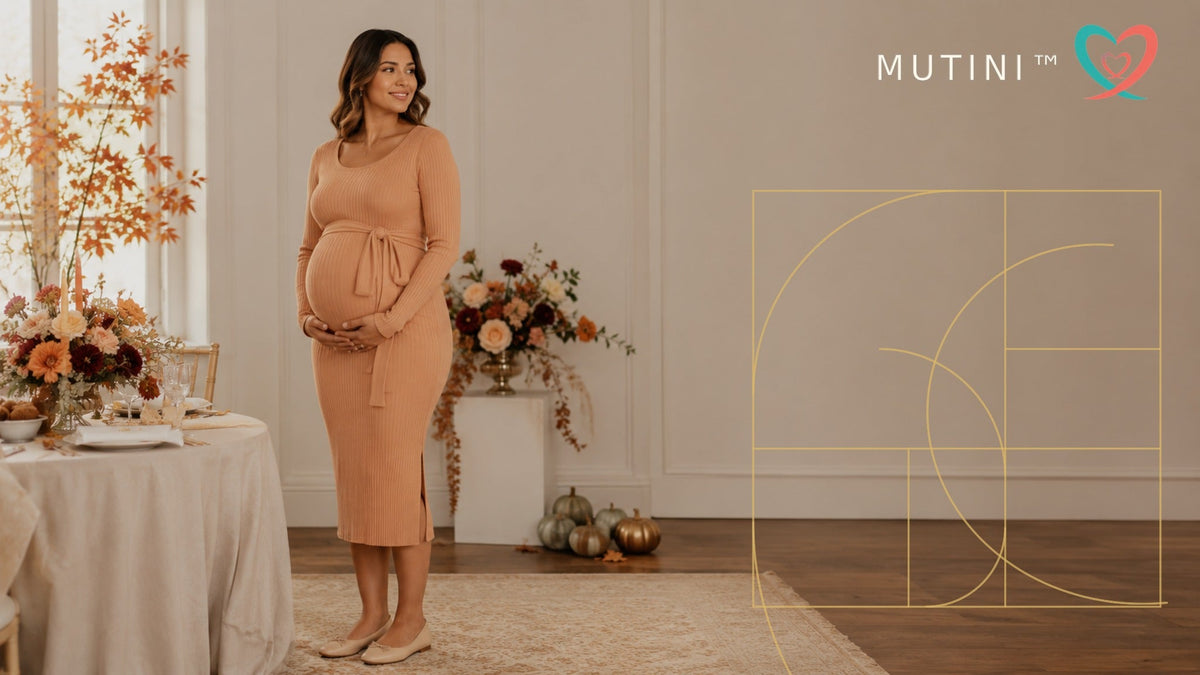 Pregnant woman in an apricot baby shower dress with MUTINI double-heart logo and golden Fibonacci design