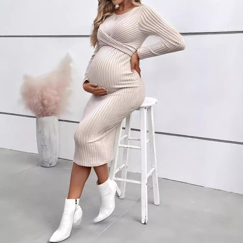 Pregnant model wearing the Apricot MUTINI ribbed long-sleeve maternity dress while seated.
